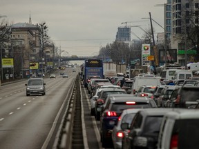 Residents seeking to leave Ukraine's capital are stuck in traffic on a highway on Thursday, Feb. 24, 2022. Countries in the European Union bordering Ukraine noted an increase of traffic as more than a million refugees are expected. Poland, Slovakia, Hungary and Romania have said they’re prepared for the influx.