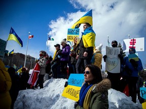 A large group of people gathered outside the Russian Embassy in Sandy Hill, Ottawa to stand united with Ukrainians and protest the Russia invasion of Ukraine, Sunday, February 27, 2022.