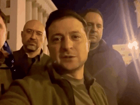 Ukrainian President Volodymyr Zelenskyy speaks alongside other Ukrainian officials in the governmental district of Kyiv, confirming that he is still in the capital, February 25, 2022.