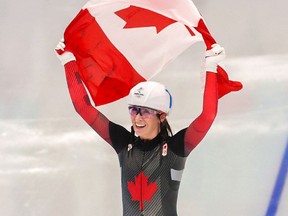 Canada's Ivanie Blondin skates with the Canadian flag after winning the silver medal in the women's mass start event at the Beijing 2022 Winter Olympics on Saturday, February 19, 2022. 

Gavin Young/Postmedia