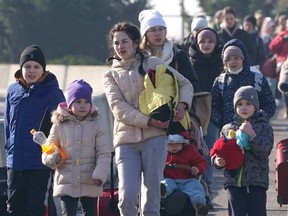 Ukrainian women and children cross the border from Ukraine to Poland at the Korczowa-Krakovets border crossing on Feb. 26.
