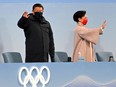 China's President Xi Jinping and his wife Peng Liyuan (R) greet the fans ahead of the opening ceremony of the Beijing 2022 Winter Olympic Games, at the National Stadium, known as the Bird's Nest, in Beijing, on Feb. 4, 2022.