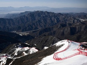 A general view show the course and snowless mountains before the start of the mens downhill third training session during the Beijing 2022 Winter Olympic Games at the Yanqing National Alpine Skiing Centre in Yanqing on February 5, 2022. (Photo by Jeff PACHOUD / AFP)