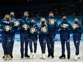 USA team's silver medallists pose during the flower ceremony of the figure skating team event during the Beijing 2022 Winter Olympic Games at the Capital Indoor Stadium in Beijing on Feb. 7.