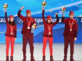 Bronze medallists of team Canada, Alexandria Loutitt, Matthew Soukup, Abigail Strate, Mackenzie Boyd-Clowes, at the Zhangjiakou Medals Plaza on Feb. 8.