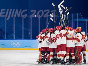 China's players celebrate victory during the women's preliminary round group B match of the Beijing 2022 Winter Olympic Games.