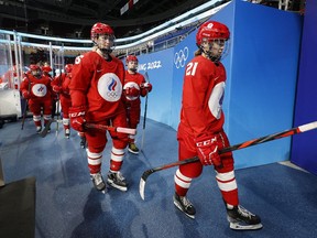 Russian Olympic Committee athletes head back after an extended delay before the game against Canada.