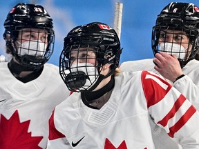 Canada's Sarah Fillier (C) and her teammates react during the women's preliminary round group A match of the Beijing 2022 Winter Olympic Games.