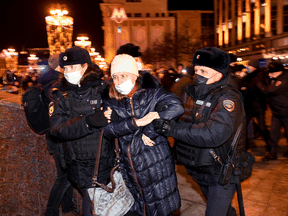 Police detain a demonstrator during a protest against Russia's invasion of Ukraine in Moscow on February 24, 2022.