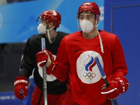 Russia athletes wearing protective face masks arrive for training.