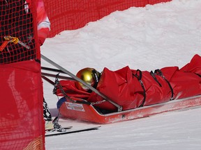 Yannick Chabloz of Team Switzerland is brought down the mountain on a sled by the medical team after crashing during the Men's Alpine Combined Downhill on day six of the Beijing 2022 Winter Olympic Games at National Alpine Ski Centre.