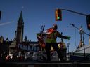 A man is dancing on stage during a protest rally in Ottawa on Monday.
