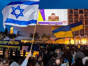 Demonstrators gather at Habima Square in the centre of Israel's Mediterranean coastal city of Tel Aviv on March 20, 2022 to attend a televised video address by Ukraine's President Volodymyr Zelensky.