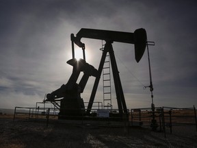 A pumpjack works at a well head on an oil and gas installation near Cremona, Alta., Saturday, Oct. 29, 2016. THE CANADIAN PRESS/Jeff McIntosh