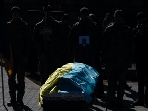 The coffin with the body of Ukrainian officer Ivan Skrypnyk is seen covered with Ukrainian national flag during the funeral ceremony on March 17, 2022 in Lviv, Ukraine. The soldier died in Sunday's airstrike on the nearby International Center for Peacekeeping and Security at the Yavoriv military complex.