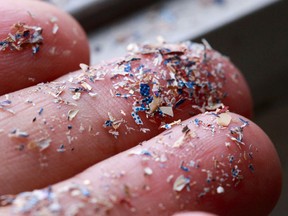 Close up side shot of microplastics lay on people hand.Concept of water pollution and global warming. Climate change idea.