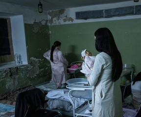 A women holds her newborn baby in the bomb shelter of a maternity hospital in Kyiv.