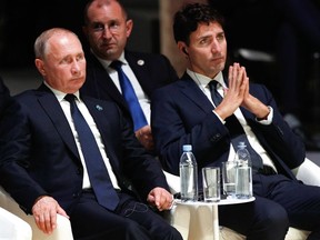 Russian President Vladimir Putin (L) and Canadian Prime Minister Justin Trudeau (R) attend the opening ceremony of the Paris Peace Forum at the Villette Conference Hall in Paris on November 11, 2018.