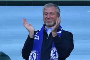 Roman Abramovich applauds Chelsea, as players celebrate their 2017 league title win at the end of the Premier League football match between Chelsea and Sunderland at Stamford Bridge in London.