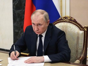 Russian President Vladimir Putin chairs a meeting with members of the Russian government via teleconference in Moscow on March 10, 2022.
