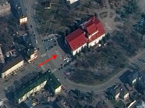 A satellite image shows a view of Mariupol Drama Theatre before it was bombed, with the word "children" written in Russian in large white letters on the pavement in front of and behind the building, in Mariupol, Ukraine, March 14, 2022.