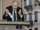 Street art depicts Russian President Vladimir Putin killing a dove, at Place de la Paix in Lyon, France. 