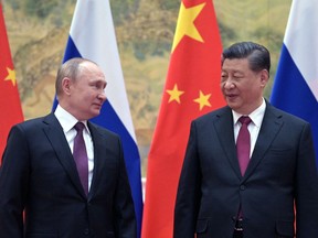 Russian President Vladimir Putin, left, and Chinese President Xi Jinping pose for a photograph during their meeting in Beijing, on Feb. 4.