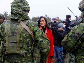 Canada's Minister of Defence Anita Anand talks with soldiers during a visit of the Adazi military base, near Riga, Latvia, on March 8, 2022. (Photo by Toms Norde / AFP)