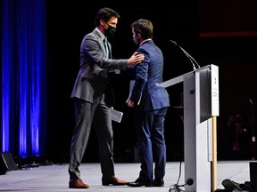 Prime Minister Justin Trudeau (L) greets Minister of the Environment and Climate Change Steven Guilbeault at the GLOBE Forum 2022 in Vancouver, British Columbia, March 29, 2022.