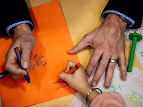 Prime Minister Justin Trudeau played, and lost, a game of tic-tac-toe against a child, following a new child-care deal announcement with Ontario Premier Doug Ford (not (not pictured) in Brampton, Ontario,  March 28, 2022. REUTERS/Carlos Osorio