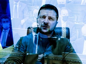 Ukrainian President Volodymyr Zelenskyy and Canadian Prime Minister Justin Trudeau are seen on a video screen as the images are merged from one to another during an
address the Canadian parliament, Tuesday, March 15 in Ottawa.