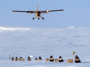 A Canadian Forces Twin Otter flies over a Canadian Ranger patrol on Ellesmere Island.