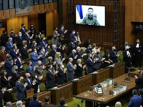 Ukrainian President Volodymyr Zelenskyy receives a standing ovation as he appears via videoconference to make an address to Parliament, in the House of Commons on Parliament Hill in Ottawa, on Tuesday, March 15, 2022. THE CANADIAN PRESS/Justin Tang