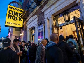 People enter the Wilbur Theatre for a sold out performance by US comedian Chris Rock in Boston, Massachusetts on March 30, 2022.