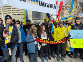 Deputy Prime Minister Chrystia Freeland, centre, holds a scarf that some people have claimed is a neo-Nazi symbol while attending a pro-Ukraine rally in Toronto on February 27, 2022.