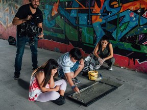Directors Rich Williamson, standing, and Shasha Nakhai work with Mekiya Fox (Sylvie), left, and Liam Diaz (Bing) in a scene from Scarborough.