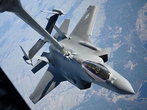 A U.S. Air Force F-35 Lightning II aircraft receives fuel from a KC-10 Extender aircraft over Poland on Feb. 24, 2022. The Canadian government, which is entering into final negotiations to purchase 88 F-35s from Lockheed Martin, may hire non-Canadian companies to train Canada's military pilots.