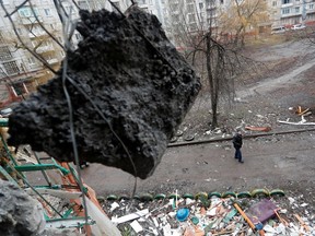 A man walks past a residential building, which locals said was damaged by recent shelling, in the separatist-controlled town of Horlivka (Gorlovka) in the Donetsk region, Ukraine March 2, 2022. REUTERS/ Alexander Ermochenko