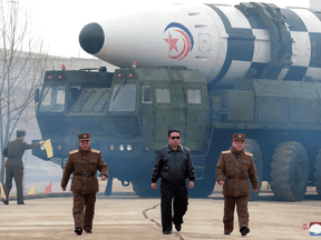 North Korean leader Kim Jong Un walks away from what state media report is a "new type" of intercontinental ballistic missile in this undated photo released on March 24, 2022 by North Korea's Korean Central News Agency.