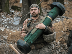 A Ukrainian service member holds a Javelin missile system at a position on the front line in the Kyiv region.