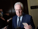 Former Quebec premier Jean Charest speaks to reporters as he arrives to meet with potential caucus supporters as he considers a run for the of the Conservative Party of Canada leadership, in Ottawa, March 2, 2022.