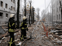 Firefighters extinguish a burning building after a Russian rocket attack in Kharkiv, Ukraine's second-largest city, Ukraine, March 2, 2022.