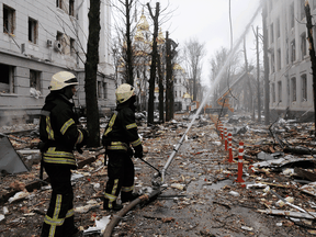 Firefighters extinguish a burning building after a Russian rocket attack in Kharkiv, Ukraine's second-largest city, Ukraine, March 2, 2022.