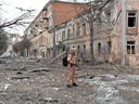 Ein Mitglied der ukrainischen Territorialverteidigungskräfte betrachtet die Zerstörungen nach einem Beschuss in Charkiw, der zweitgrößten Stadt der Ukraine am 7. März 2022.