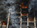 A fire burns in an apartment building in Kyiv on March 15, 2022, after strikes on residential areas killed at least two people, Ukraine emergency services said as Russian troops intensified their attacks on the Ukrainian capital.