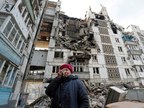 Local resident Valentina Demura, 70, reacts next to the building where her apartment, destroyed during Ukraine-Russia conflict, is located in the besieged southern port city of Mariupol, Ukraine March 27, 2022. Valentina worked for many years at the Azovstal Iron and Steel Works. After her apartment was destroyed, she lives with neighbors in their apartment, and they take shelter together in the basement.