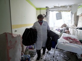 A medical worker walks inside of the damaged by shelling maternity hospital in Mariupol, Ukraine, Wednesday, March 9, 2022.