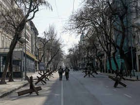 Soldiers walk in an empty street of Odesa on March 17, 2022. Odessa, which Ukraine fears could be the next target of Russia's offensive in the south, is the country's main port and is vital for its economy.