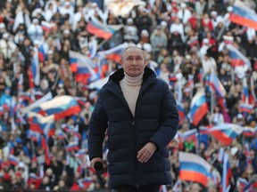 Russian President Vladimir Putin attends a rally at the Luzhniki stadium in Moscow on March 18, 2022. (Photo by Mikhail KLIMENTYEV / SPUTNIK / AFP)
