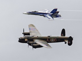 The CF-18 Demo team fighter jet painted to commemorate the 60th anniversary of NORAD conducts a heritage fly-past with the Avro Lancaster bomber from the Canadian Warplane Heritage Museum on Wednesday August 29, 2018 in Brantford, Ontario.